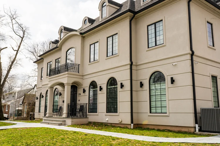 Custom home built by Omar Construction in Passaic County, NJ — French-inspired stucco exterior with arched windows, Best of Houzz 2025 winner