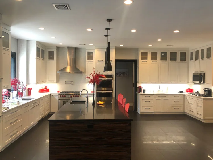 Custom kitchen renovation by Omar Construction in Passaic County, NJ — white shaker cabinets, dark stone countertops, professional appliances