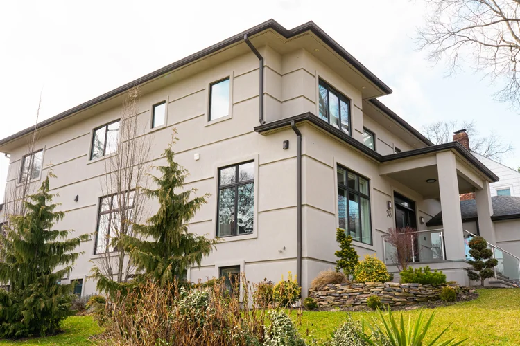 Custom home built by Omar Construction in Passaic County, NJ — modern stucco residence with steel windows, licensed general contractor