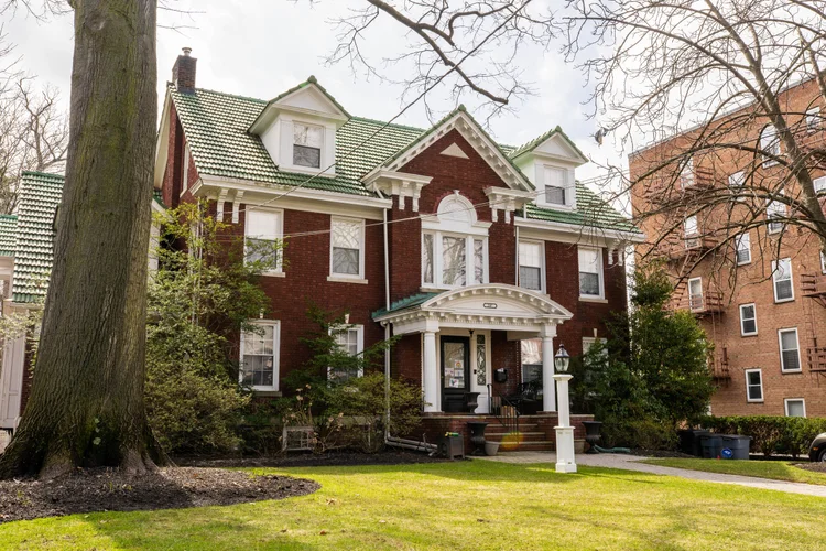 Brick colonial home renovation completed by Omar Construction in Passaic County, NJ — full structural restoration with green tile roof