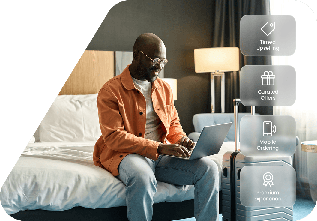 Hotel guest using a laptop in his room, with icons highlighting mobile ordering, timed upselling and curated guest offers.