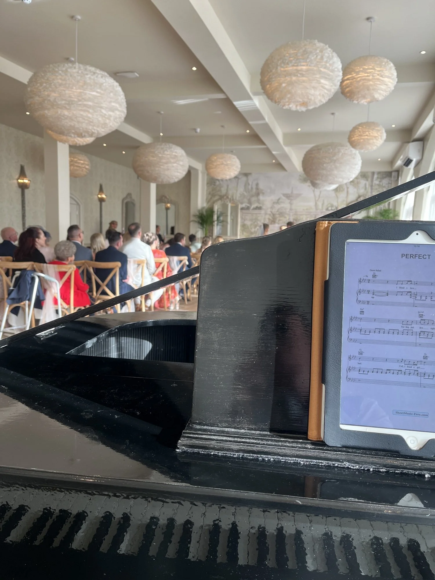 Recommended wedding pianist Chris Morris playing a ceremony at Wennington Hall on his grand piano