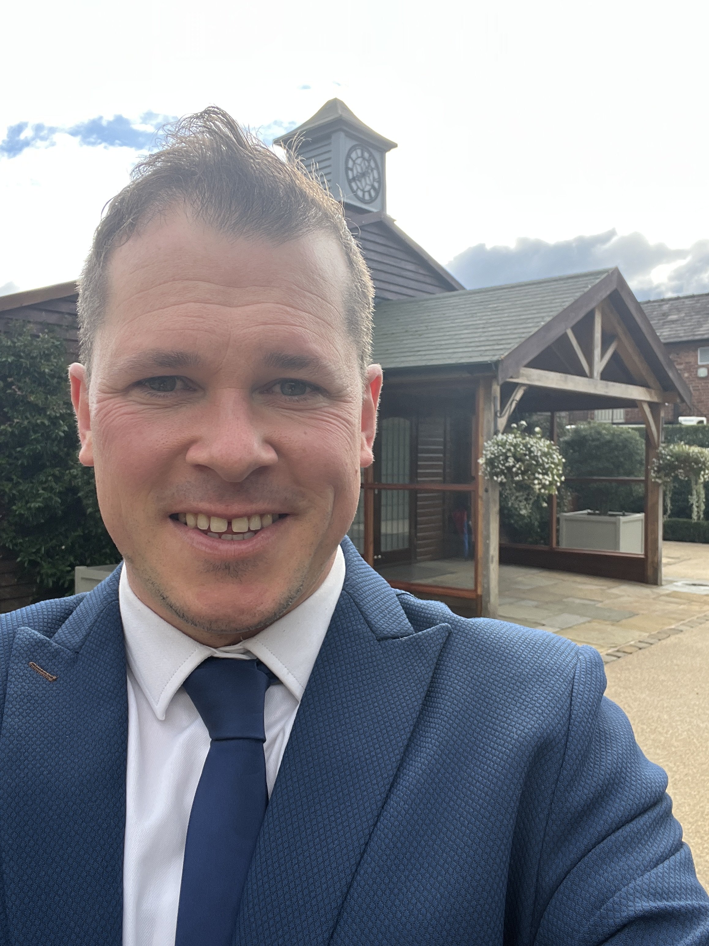 Award winning pianist Chris Morris outside Merrydale Manor in a smart blue suit