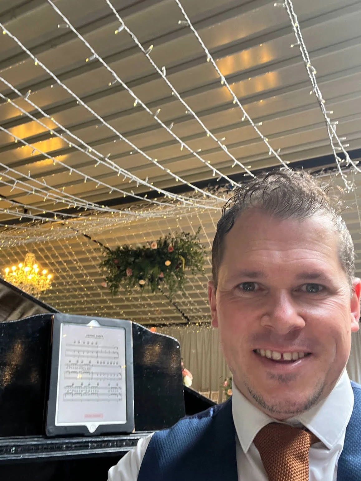 Award winning wedding pianist Chris Morrris by his grand piano at Delamere Manor