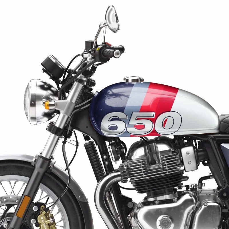 Close-up of a motorcycle with a custom paint job and the number 650 on the gas tank.