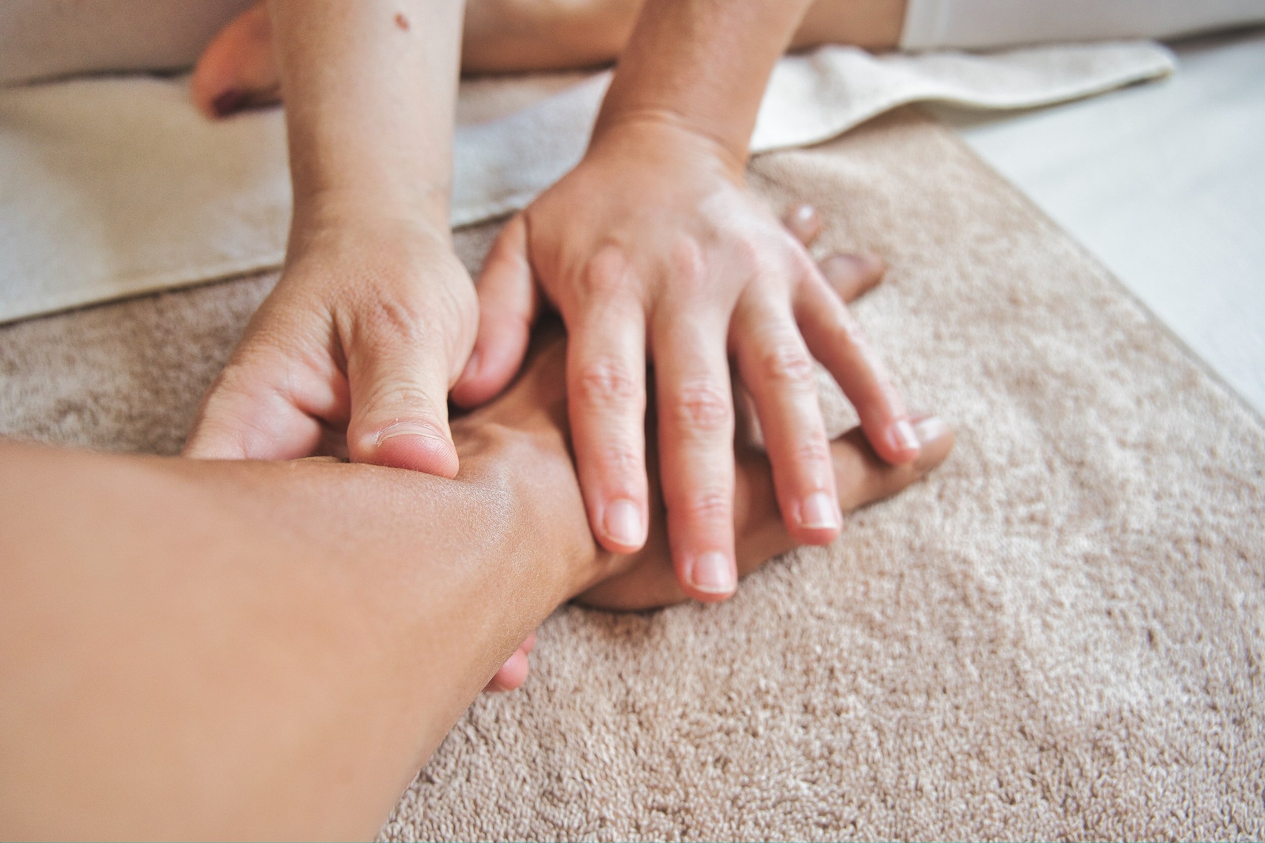 A pair of hands massages another' person’s arm, indicating they have tendonitis or carpal tunnel