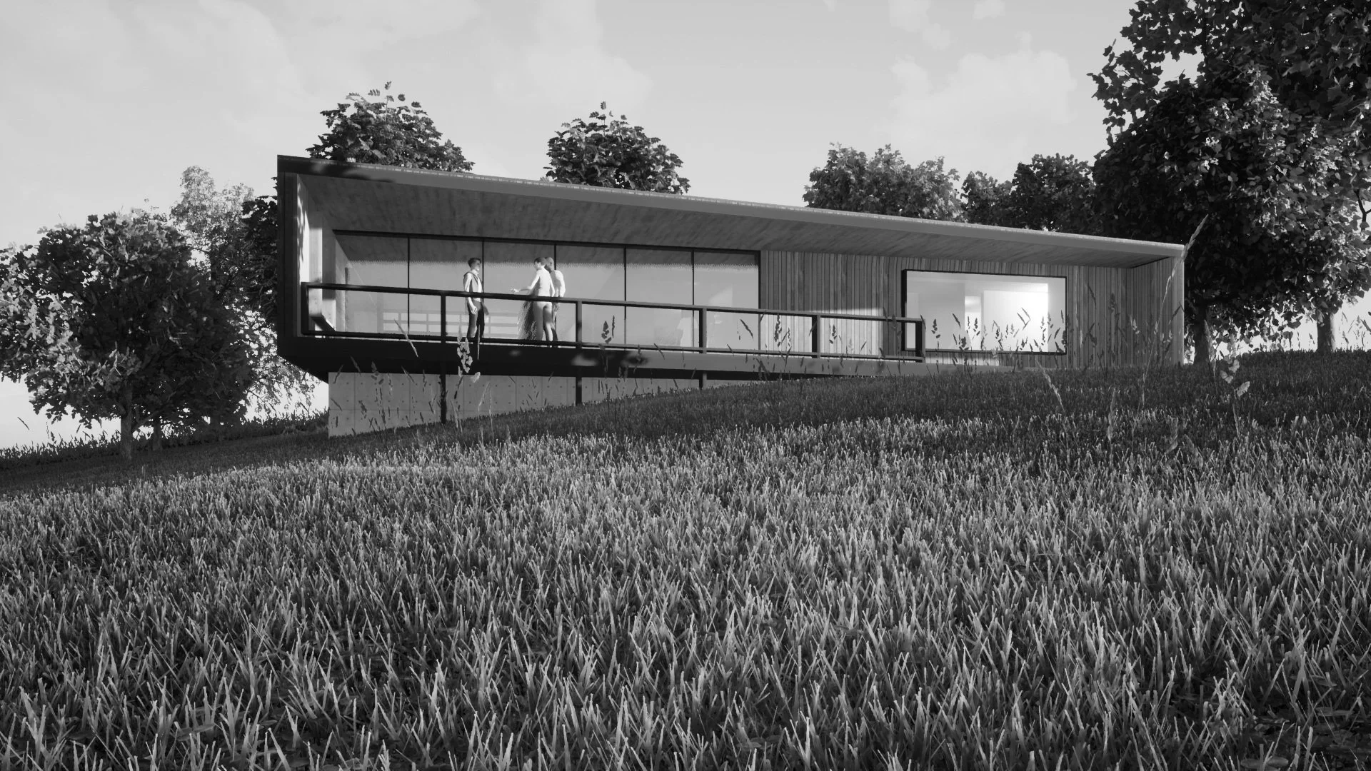 A modern house with large glass windows and a balcony, situated on a grassy hillside with trees around.