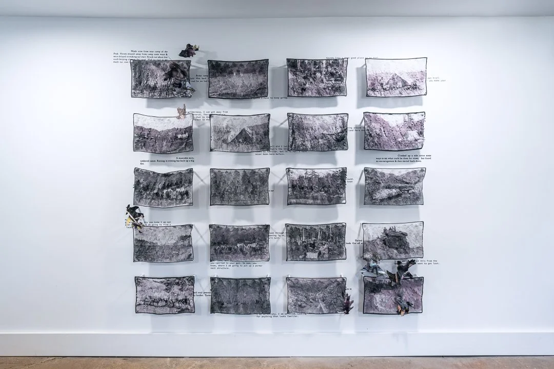 A picture of an installation of a grid of fiber pieces.