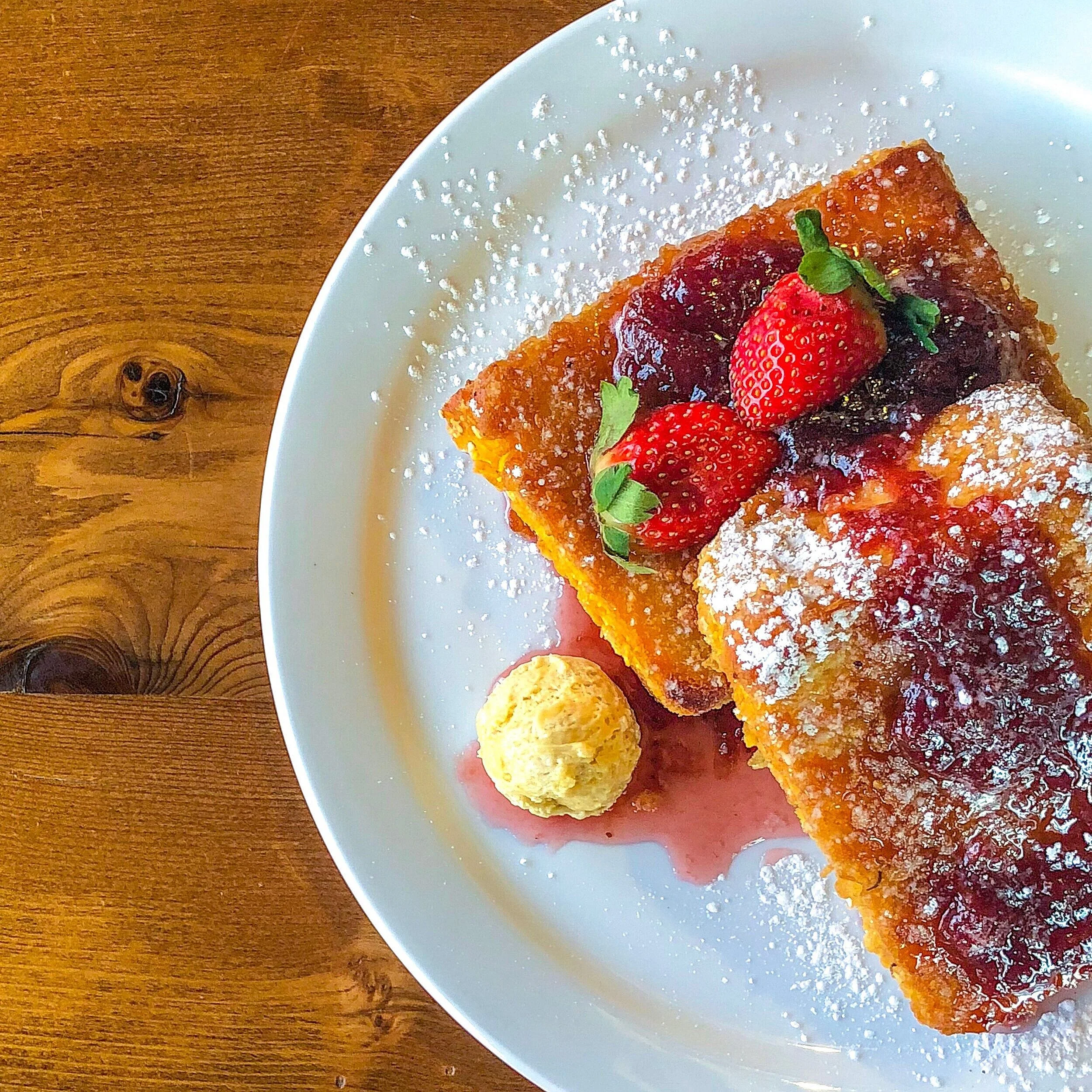 French toast topped with strawberries and berry compote at SCHOOL Restaurant in Liberty Village, Toronto.