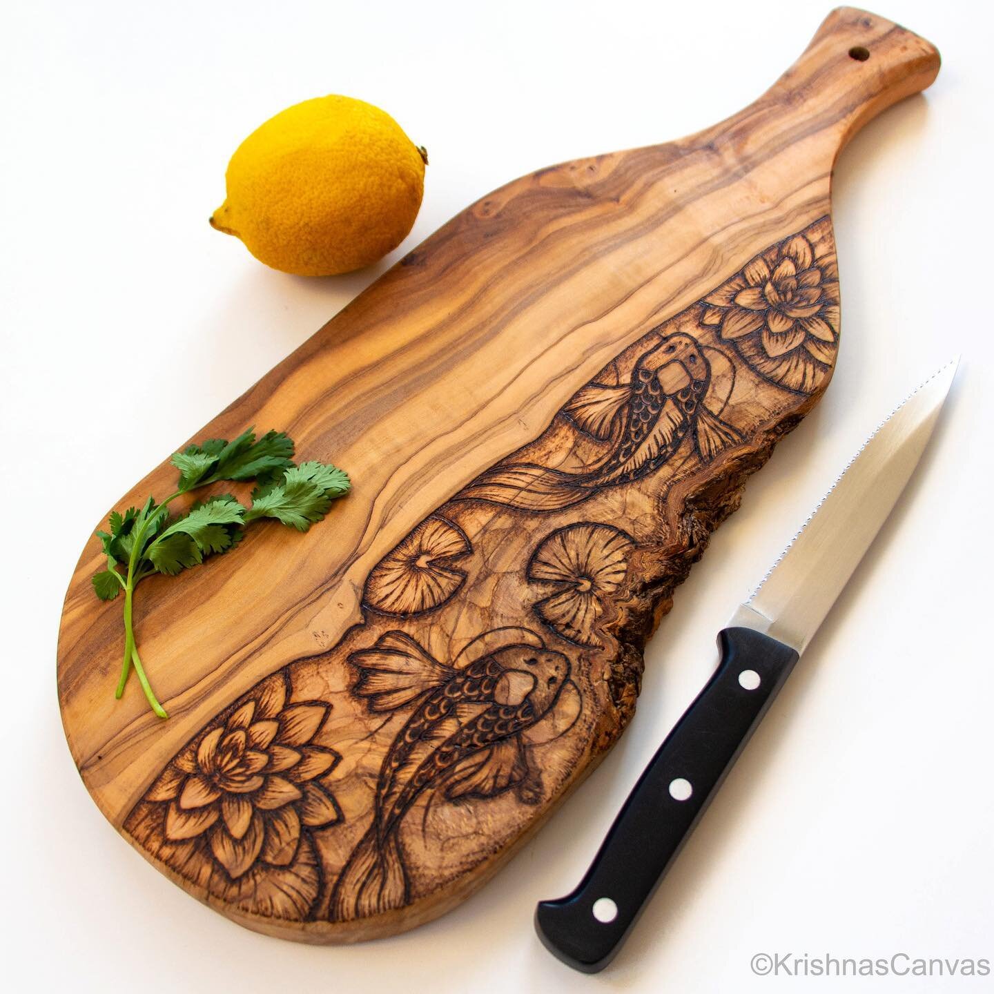 This koi fish cutting/serving board is burned on a beautiful piece of olive wood! Just look at those grains and a bit of bark on the side! 

I extended my Black Friday deal till Saturday 12/3! Get 10% off all ready-made wood products with the discoun