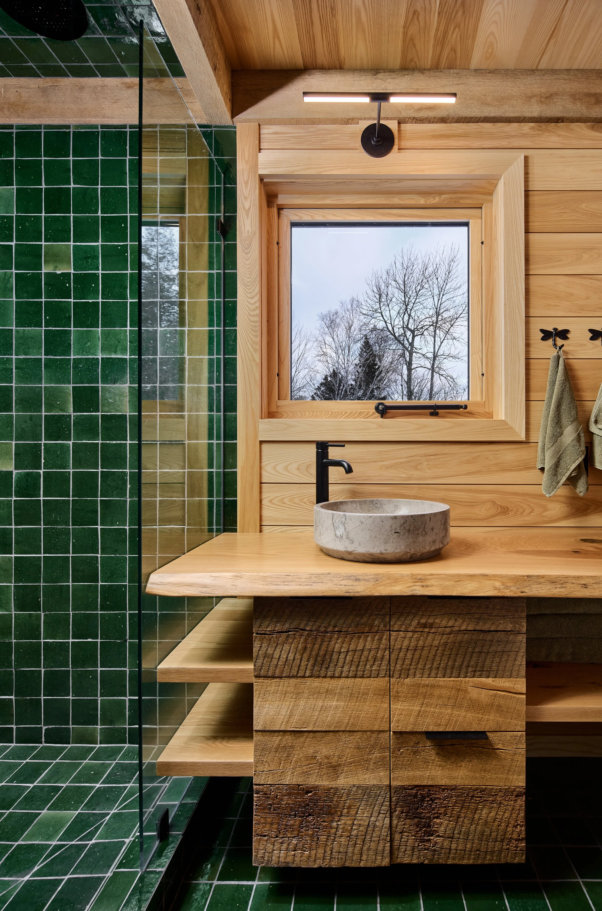 Tile and live-edge carpentry in custom built home in Lutsen, Minnesota on the North Shore of Lake Superior.