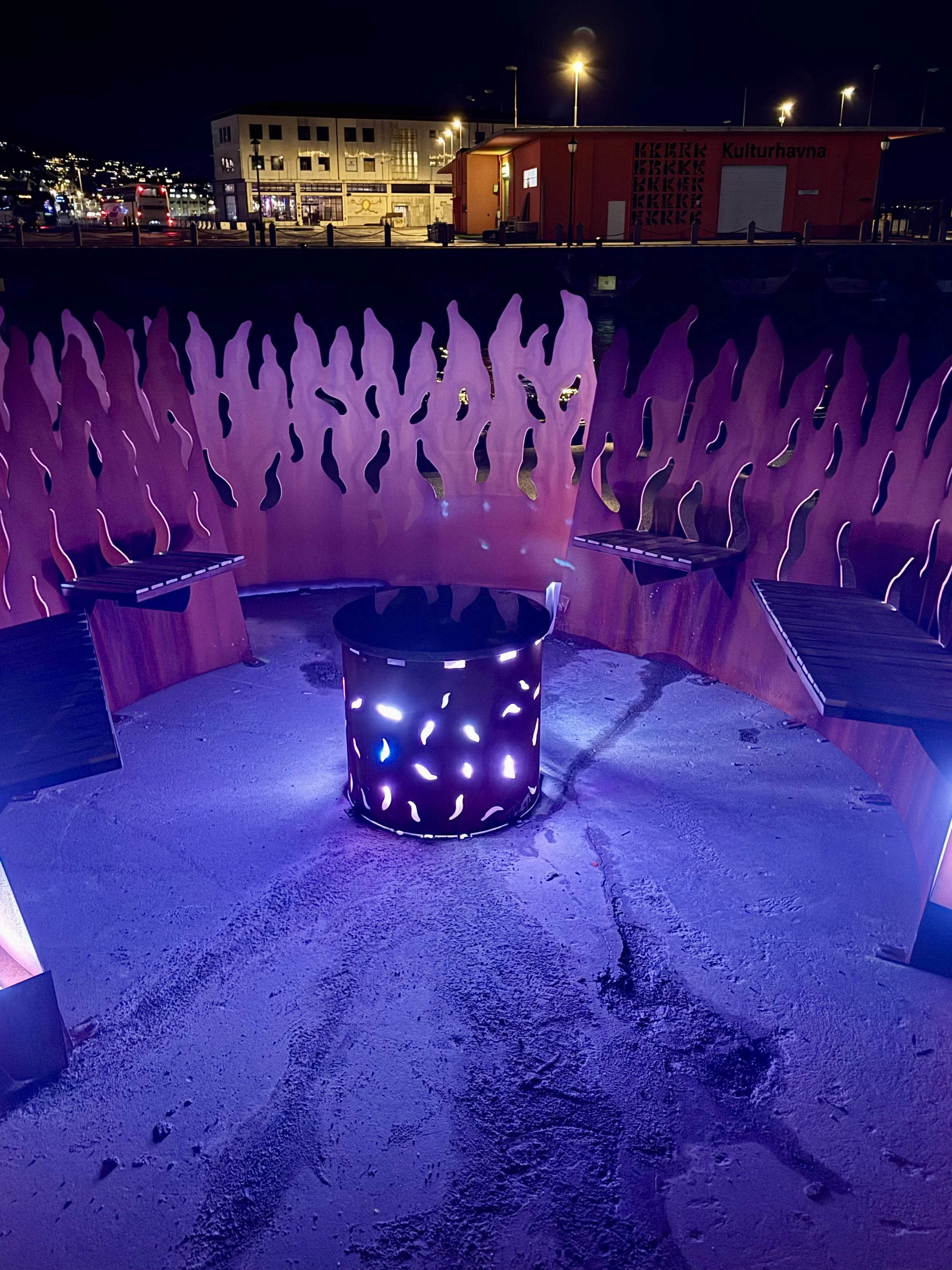 The Bonfire Ålesund night view with seats around the fireplace 4