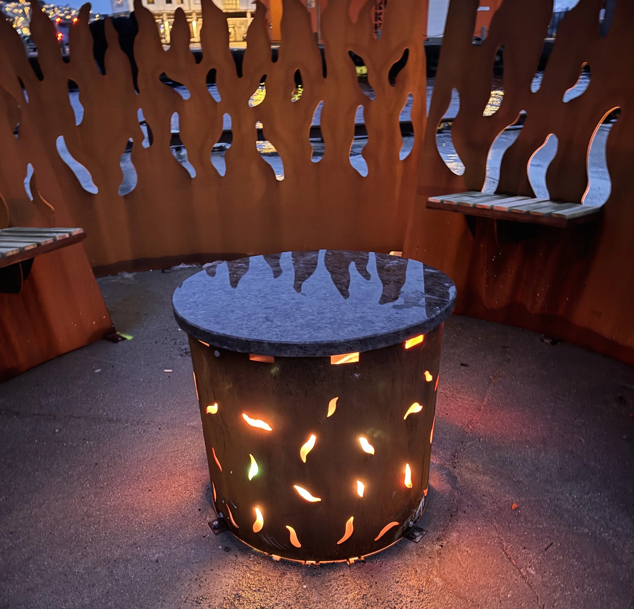 The Bonfire Ålesund night view with seats around the fireplace 1