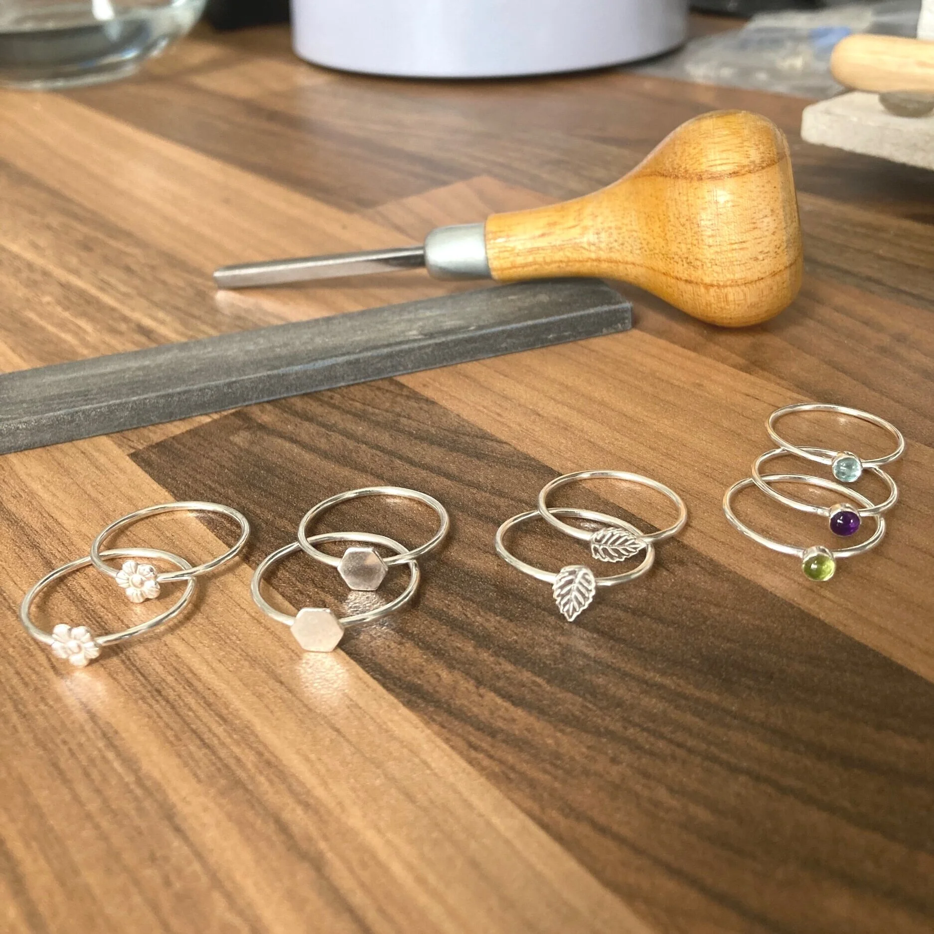 silver stacker rings on work bench handmade dainty