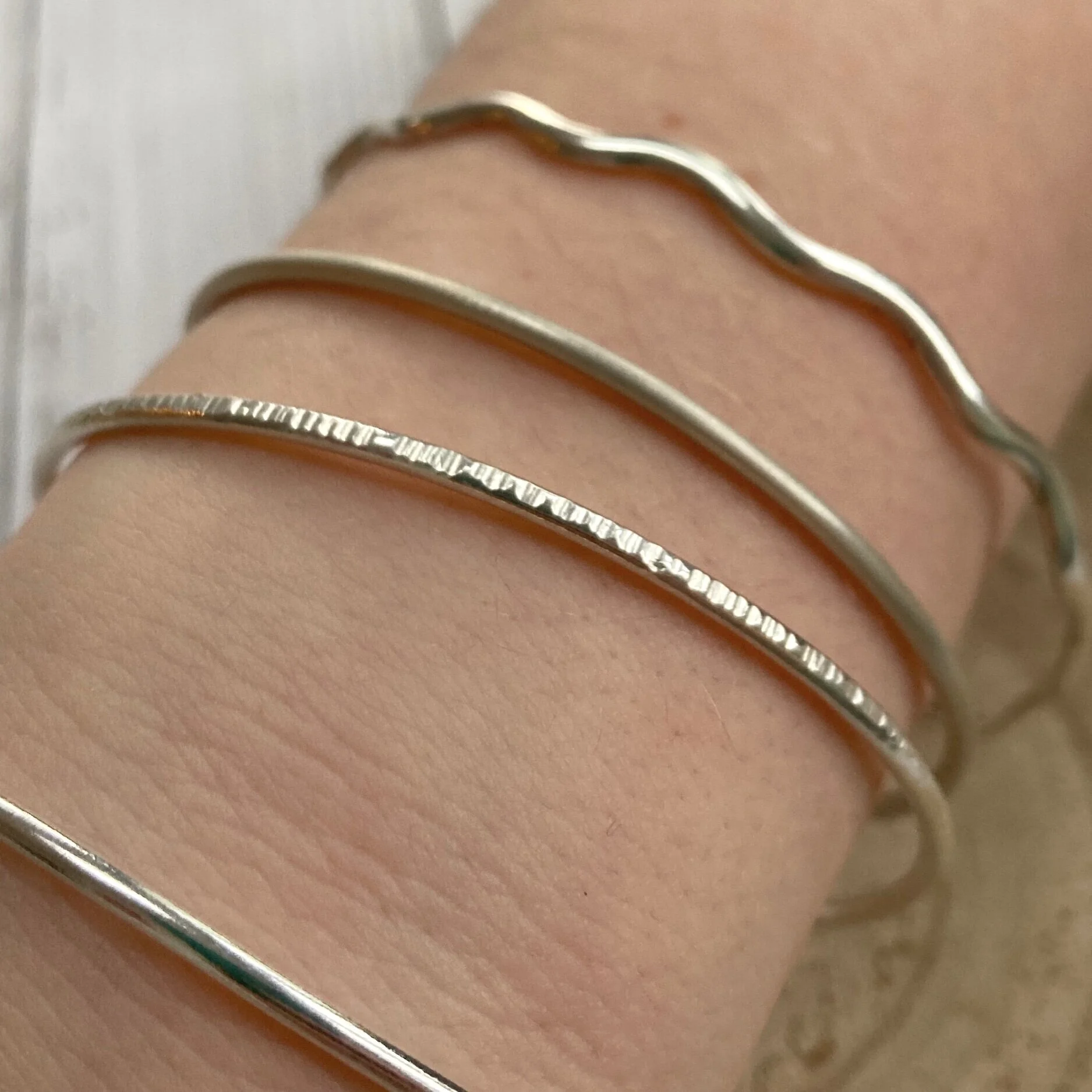 silver bangles on arm