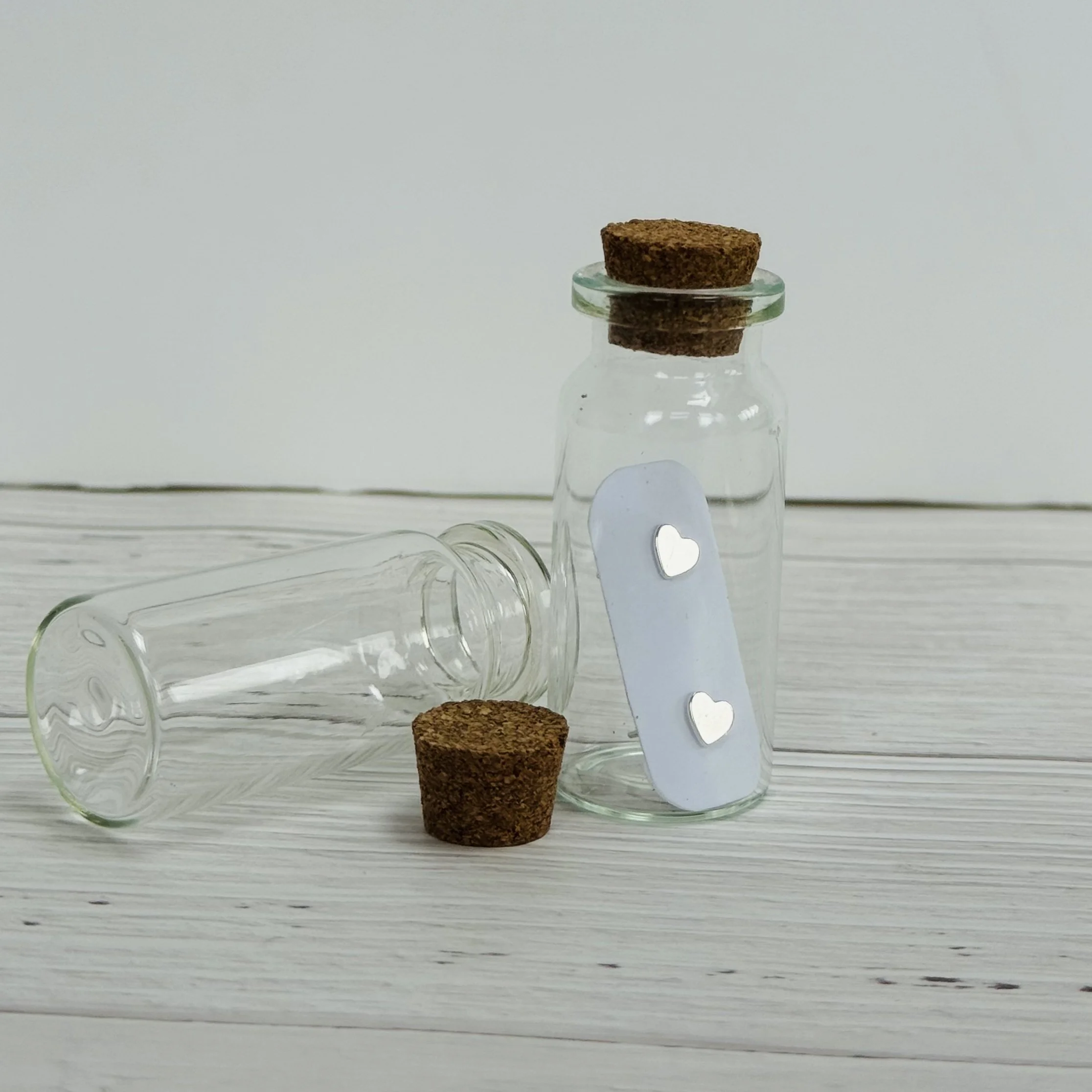 glass bottle with slver heart studs in