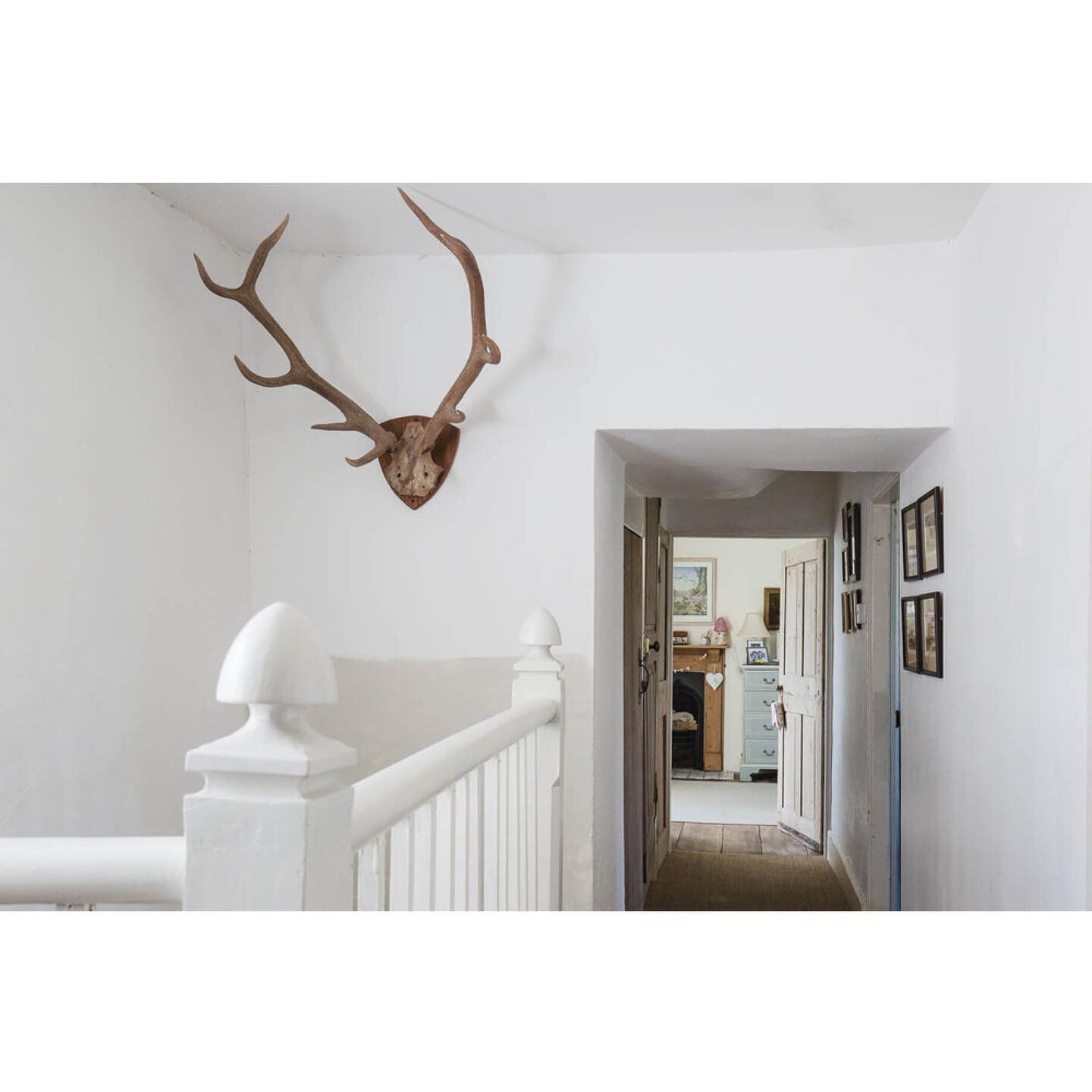 Less is sometimes more.  The plain white decor with the wooden floor and original pine doors works well on the landing of this traditional farmhouse.  We are drawn to the bedroom down the corridor. I love the period touches to the children's bedroom 