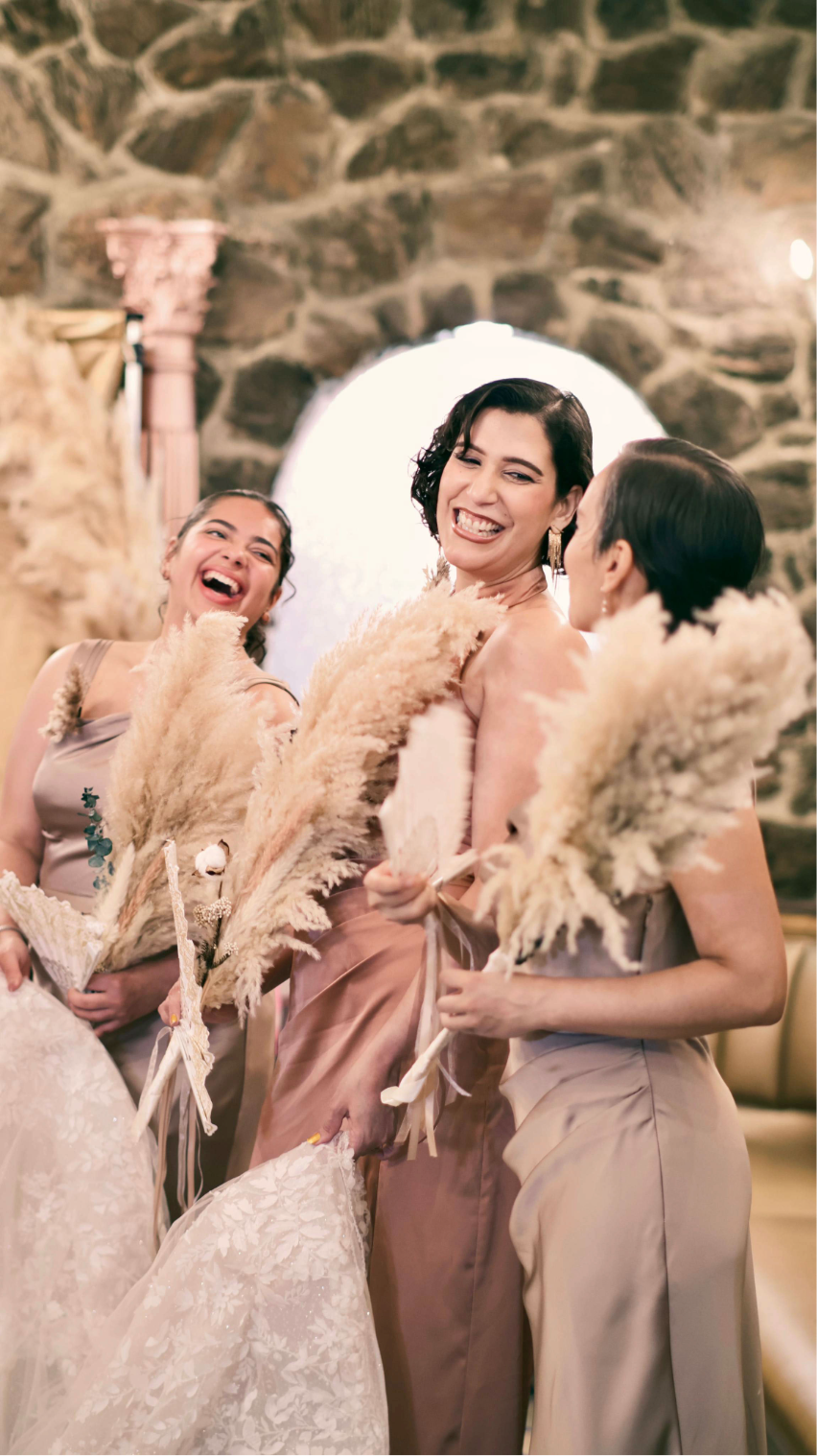 Bridesmaids laughing together during a wedding celebration.
