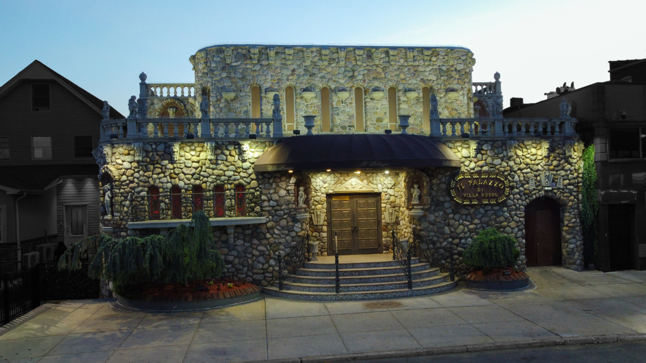 Exterior of Il Palazzo di Villa Russo in Richmond Hill, Queens, showing the stone façade and main entrance.