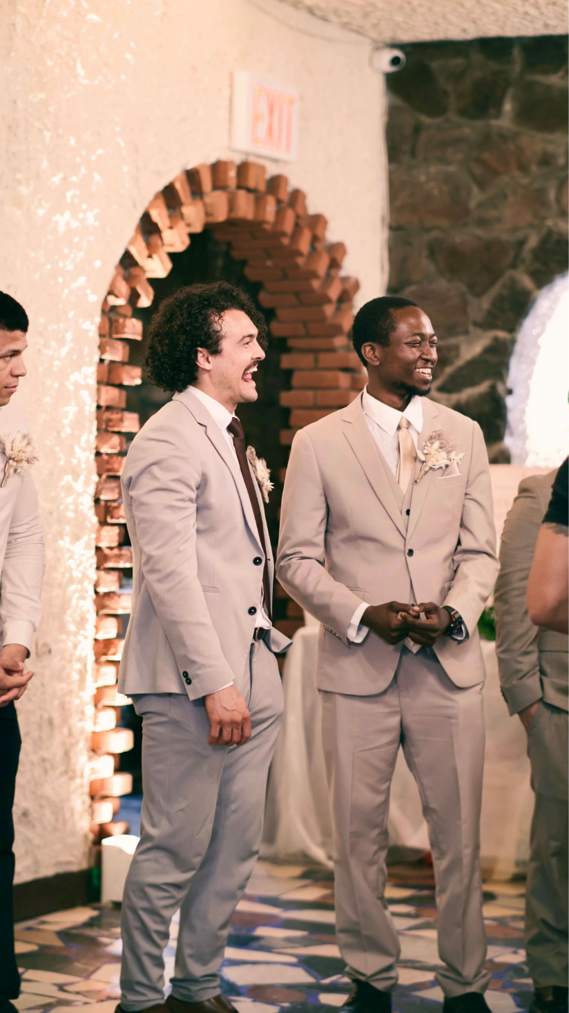 Groomsmen sharing a candid moment during the wedding reception.