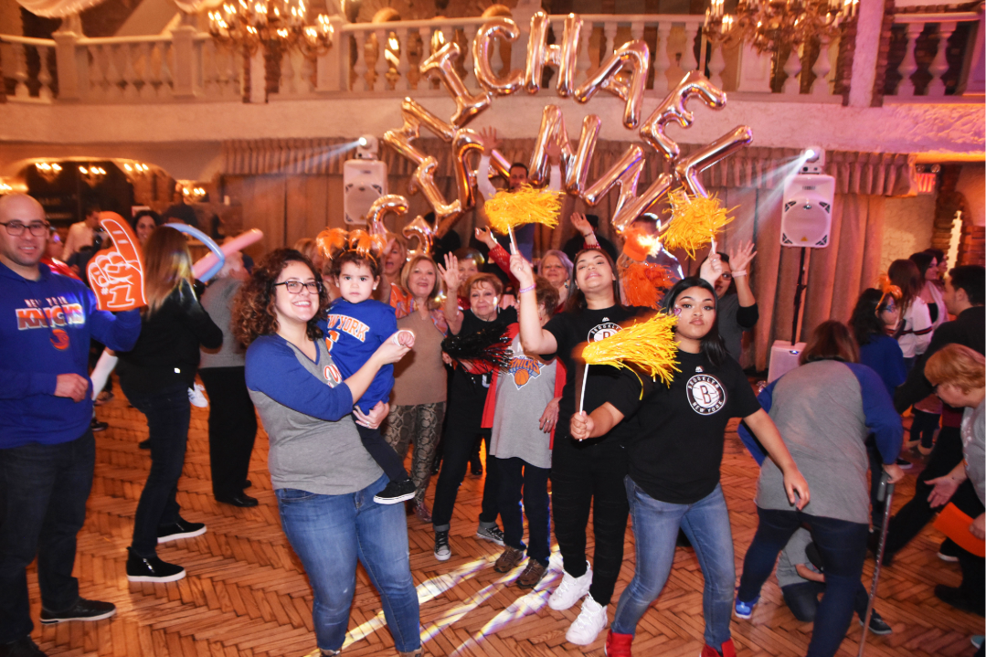 Guests celebrating during a basketball-themed banquet with custom decorations and entertainment.