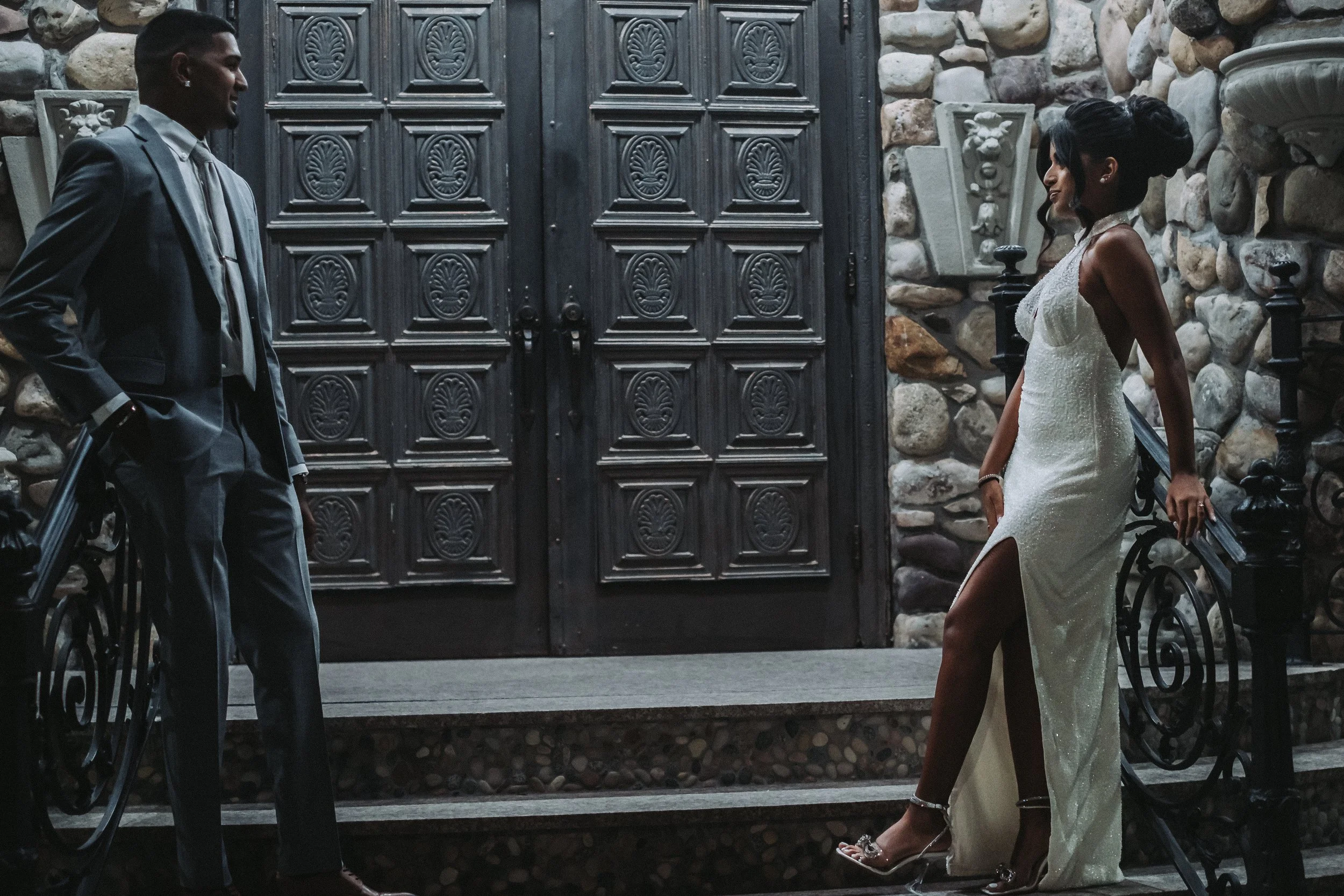 Bride and groom posed on stone staircase at Villa Russo with romantic wedding setting in Queens NY