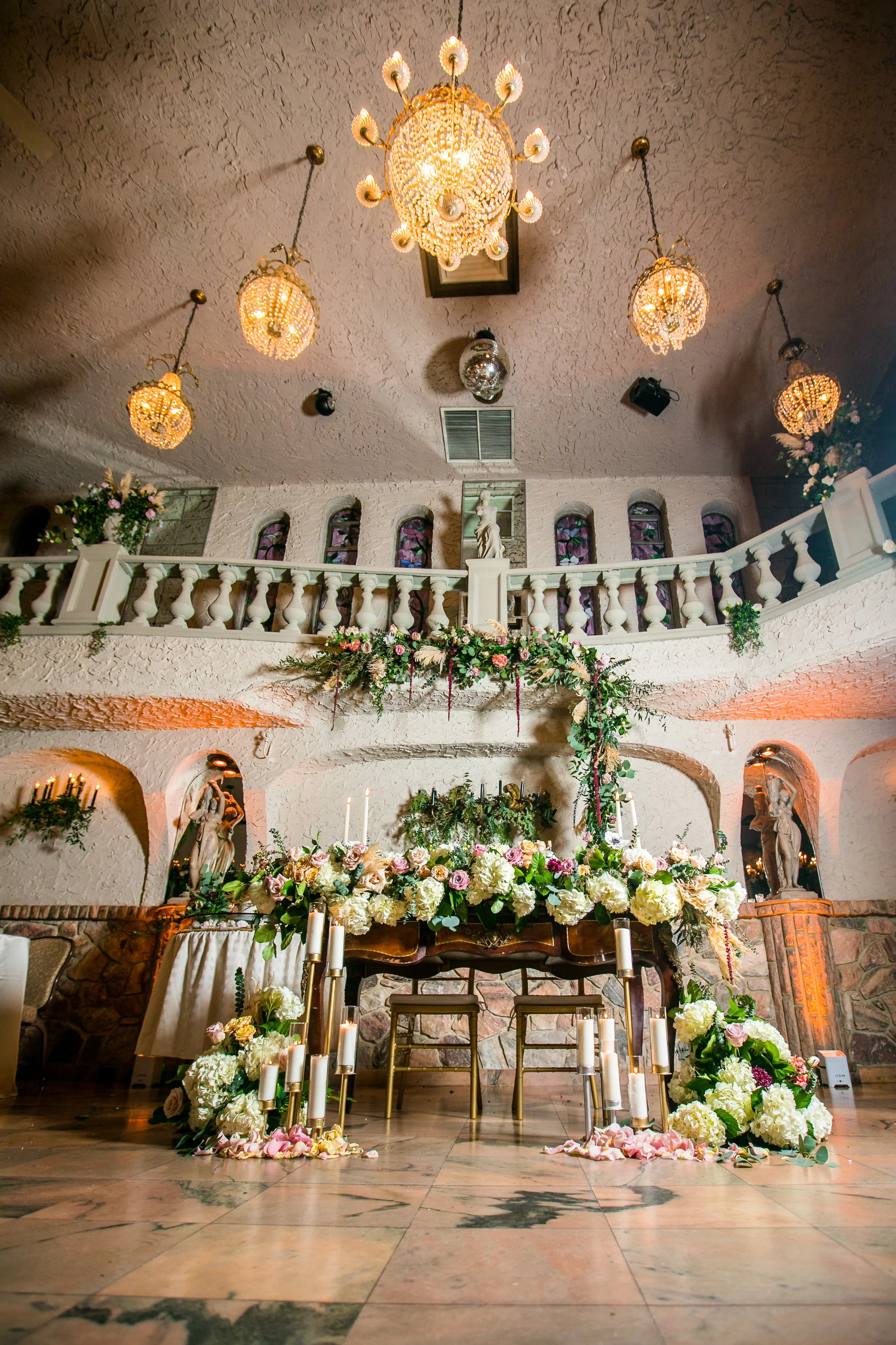Unique wedding ceremony setup with chandeliers and balcony at Villa Russo venue in Queens NY