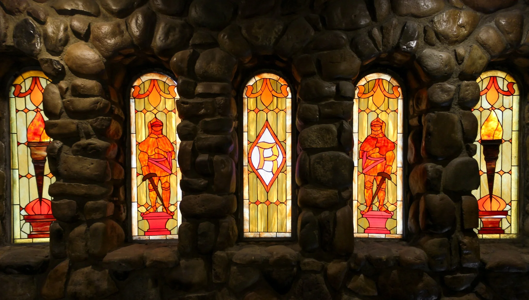 Stained glass windows at Villa Russo wedding venue in Queens NY with stone interior details