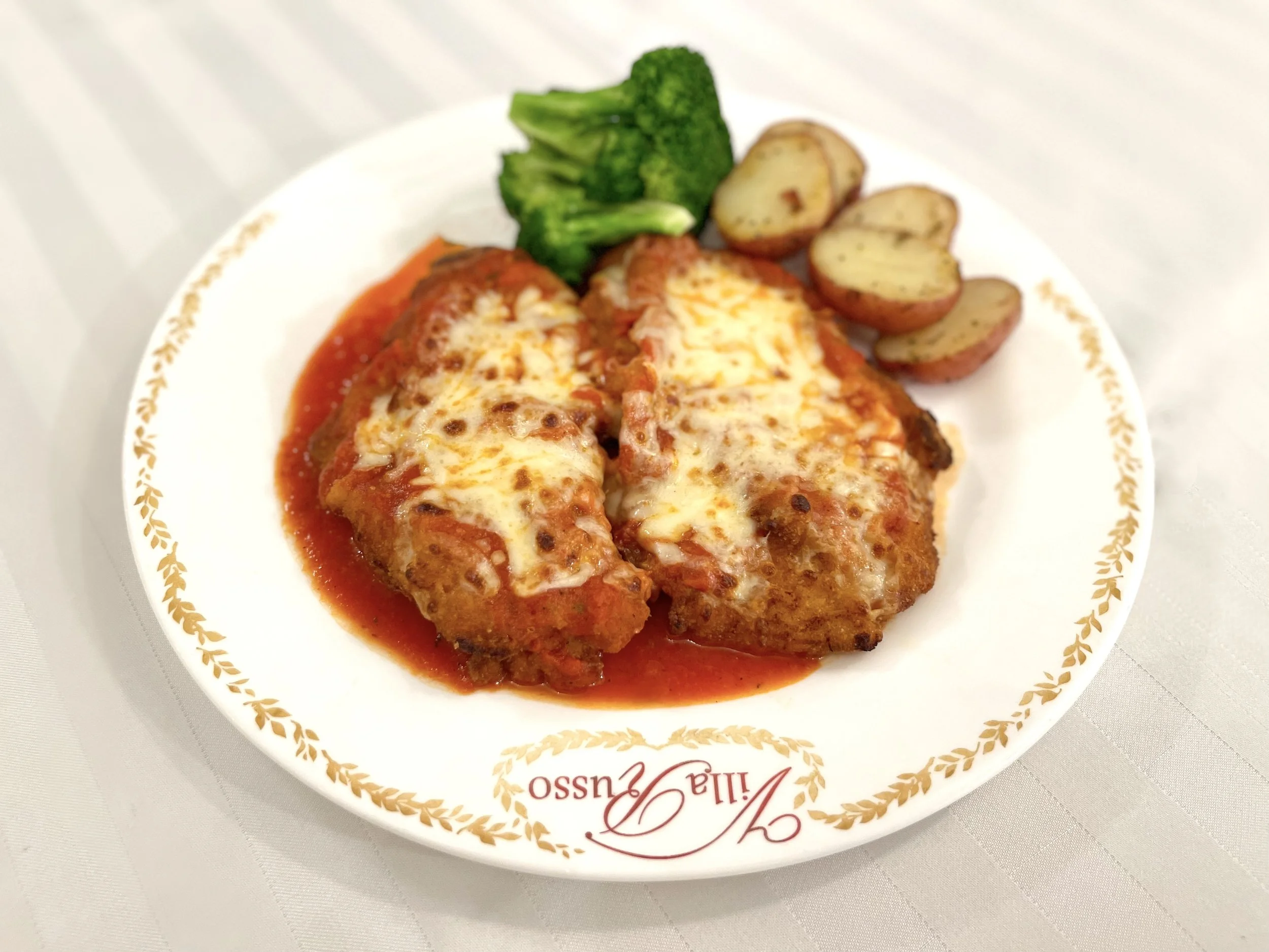 Baked chicken entrée with vegetables at Villa Russo catering Queens NY