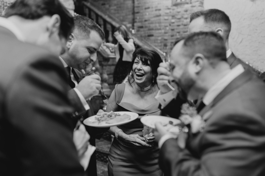 Wedding guests laughing and enjoying cocktail hour at Villa Russo.