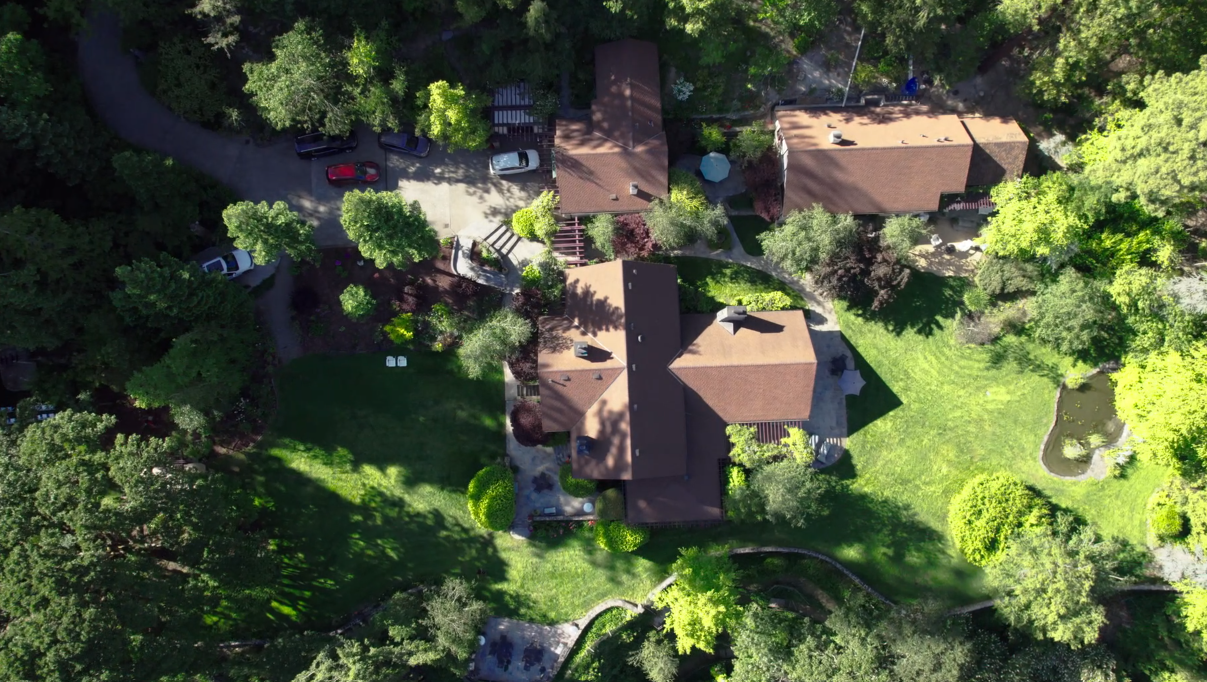 Aerial view of 3 buildings and surrounding lawns