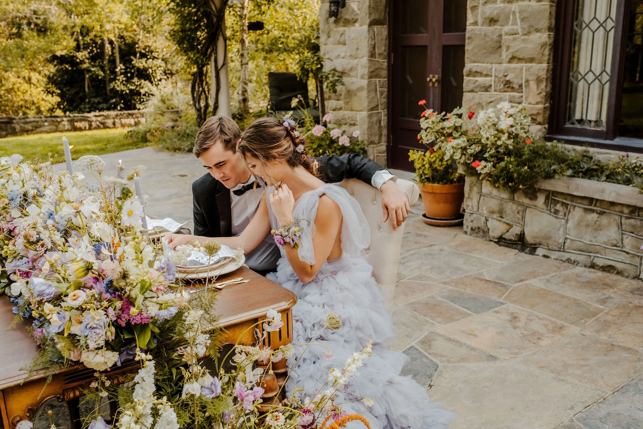 Bridge and groom siting at a table in front of the great room