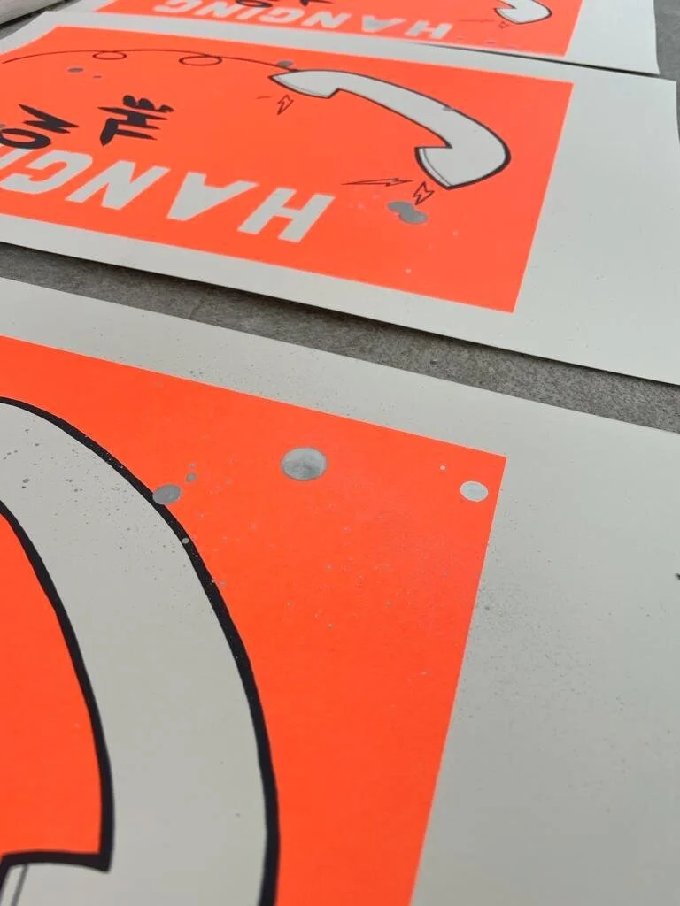 Close up of neon orange art screenprint, 80s music theme art
