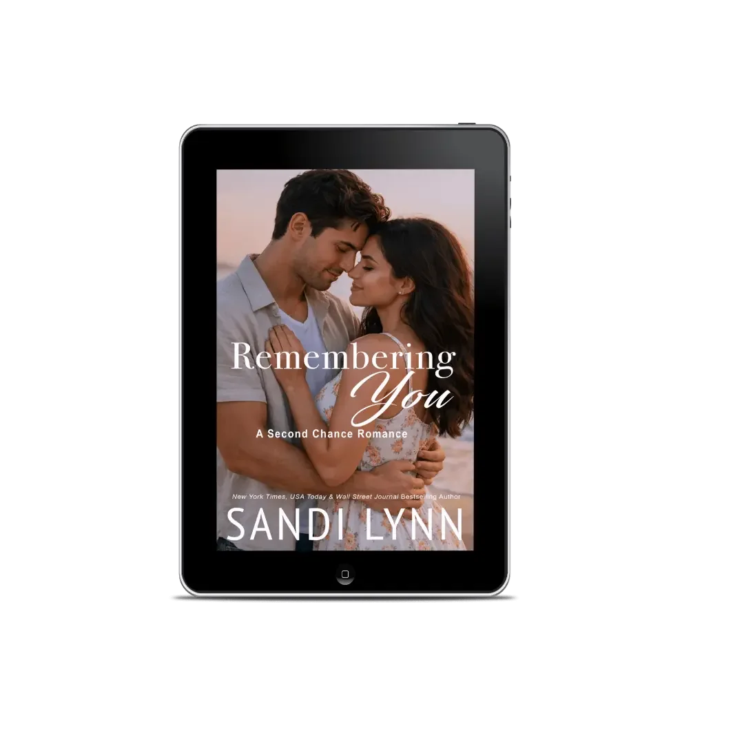 Digital book cover for 'Remembering You: A Second Chance Romance' by Sandi Lynn, featuring a romantic close-up photo of a man and woman embracing on a beach at sunset.