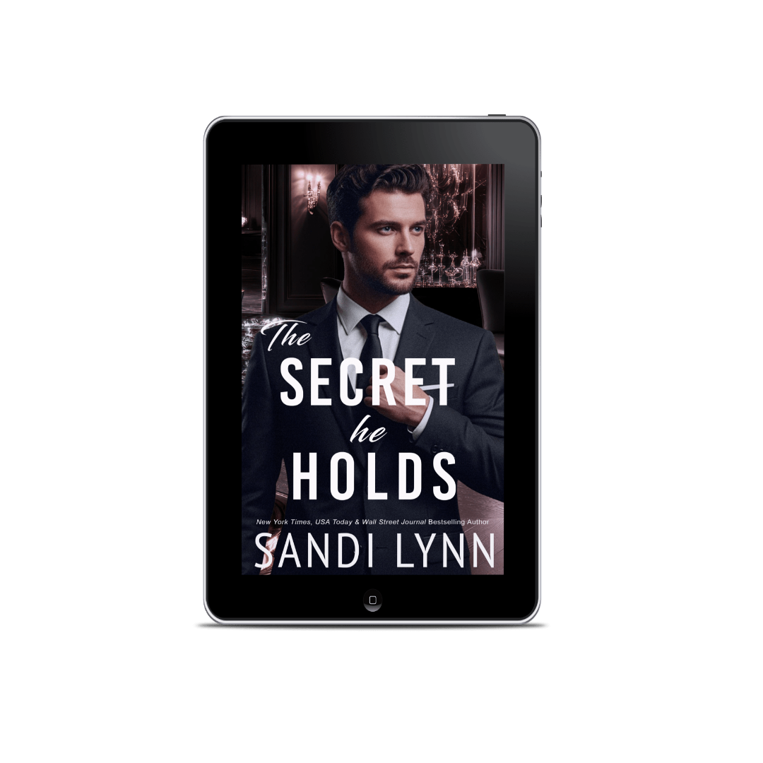 Ebook cover titled 'The Secret He Holds' by Sandi Lynn, featuring a man in a suit with a serious expression, set against a dark, elegant background with chandeliers.