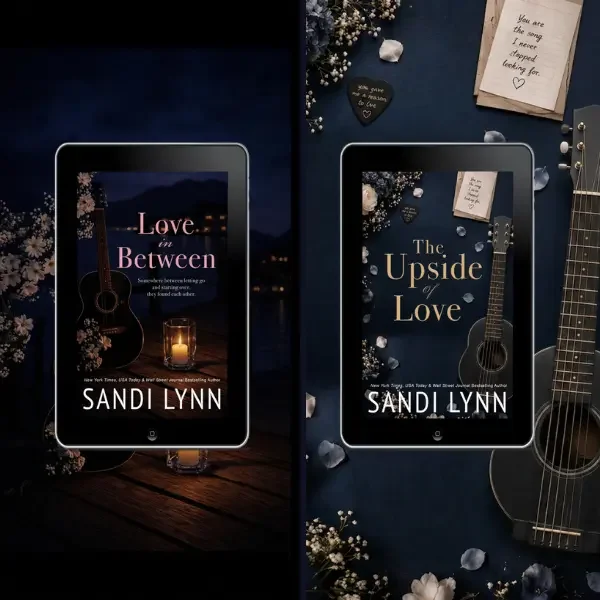 Two tablet screens displaying book covers by Sandi Lynn. The left cover titled 'Love in Between' shows a candle and guitar with a dark sunset background. The right cover titled 'The Upside of Love' features a guitar, flowers, and scattered stones, with a dark blue background.