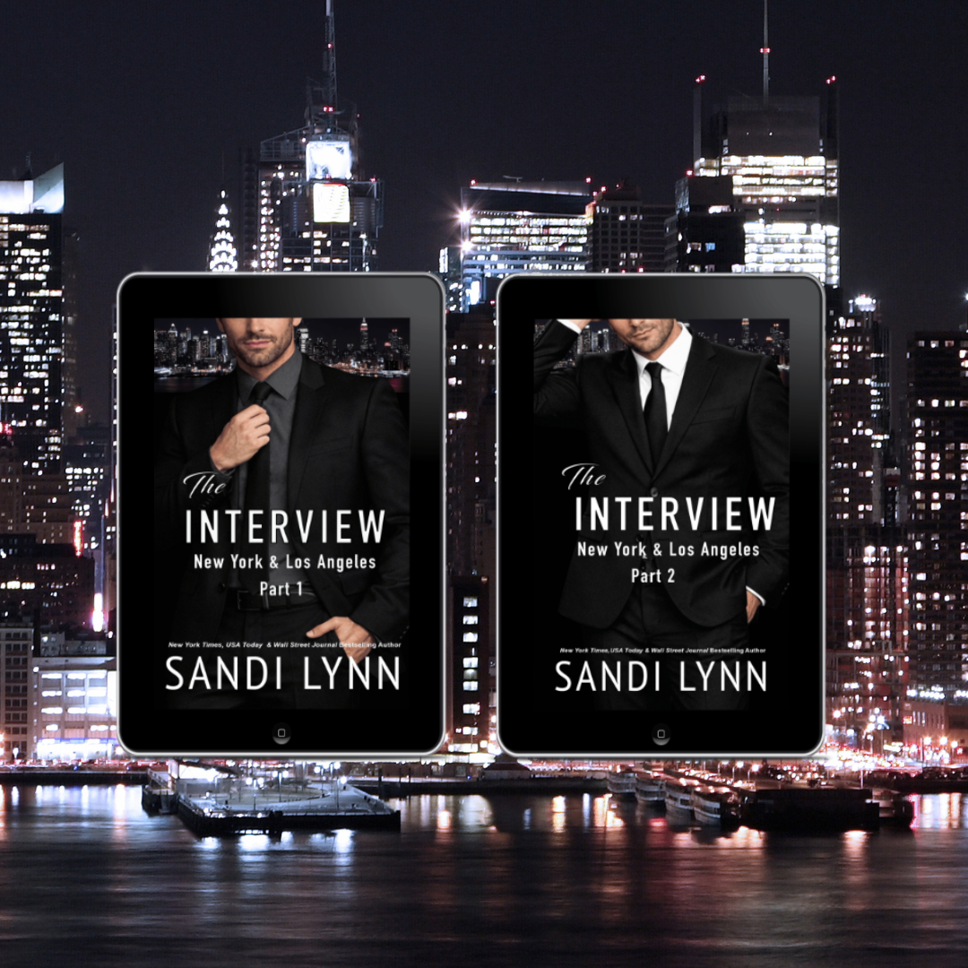 Two e-reader devices displaying book covers of 'The Interview' by Sandi Lynn; one titled Part 1 and the other Part 2, against a city skyline at night with illuminated buildings and a river in the foreground.