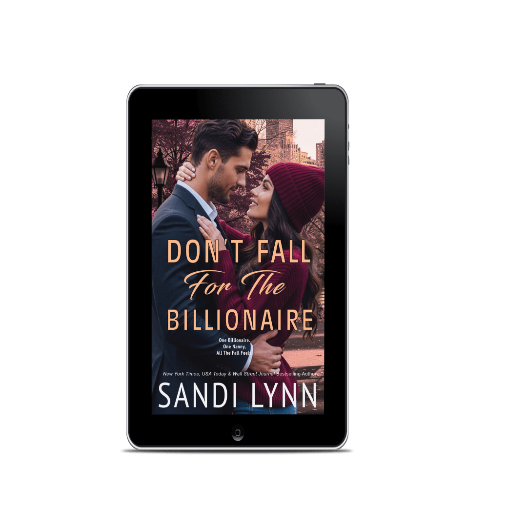 Book cover titled "Don't Fall for the Billionaire" by Sandi Lynn, featuring a man and woman in an outdoor setting with autumn trees, with the title and author's name displayed on the screen of a tablet device.