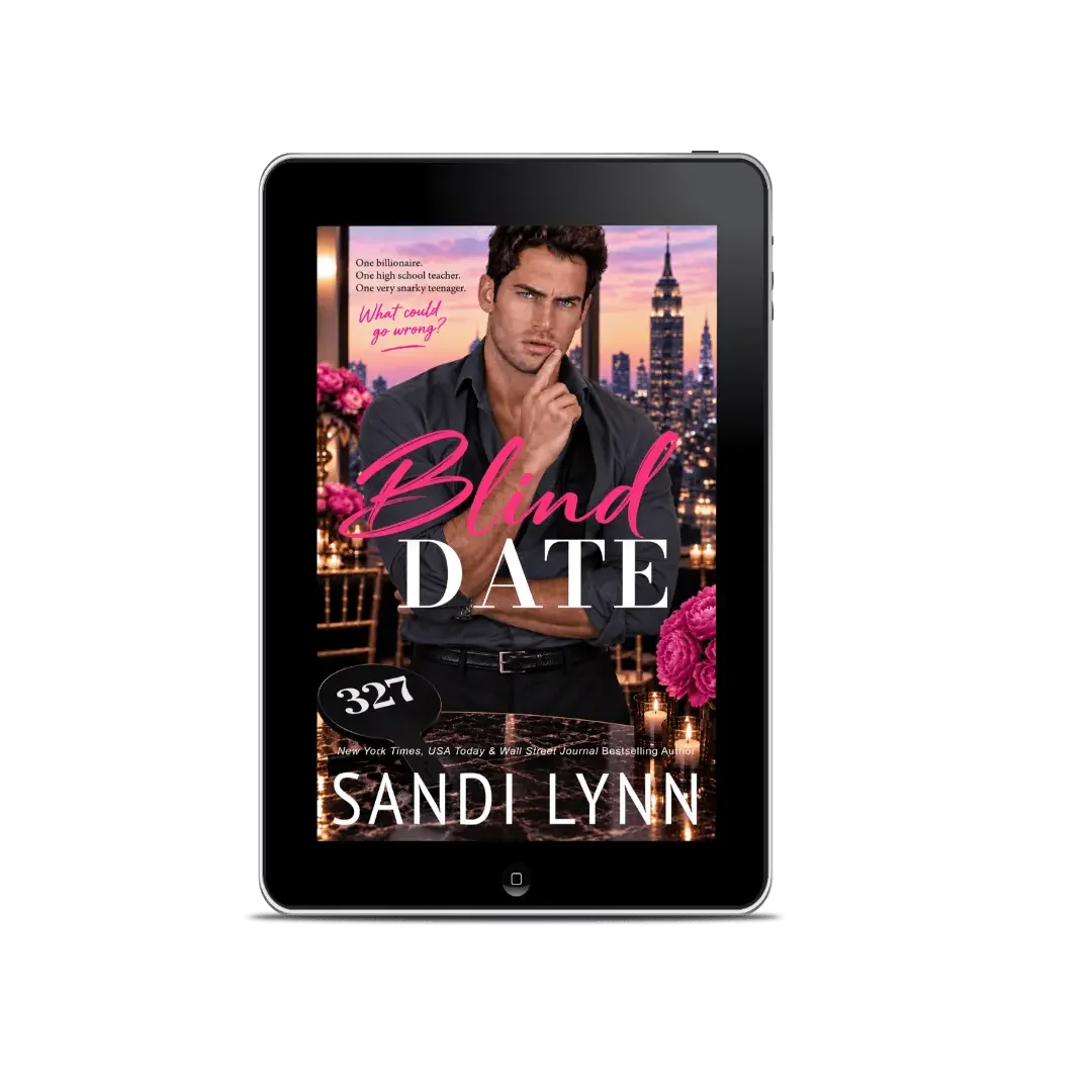 Book cover titled 'Blind Date' by Sandi Lynn, features a man with dark hair, dressed in black, standing against a city skyline at sunset with pink flowers and candles in the foreground.