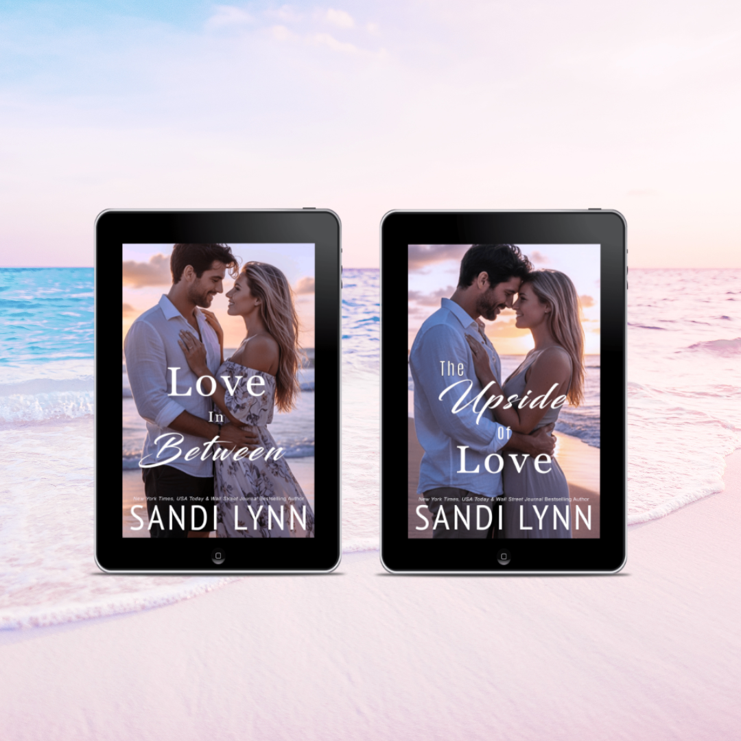 Two e-readers displaying the covers of a romance novel titled 'Love in Between' and 'The Upside of Love' by Sandi Lynn, positioned on a beach with ocean waves and a sunset in the background.