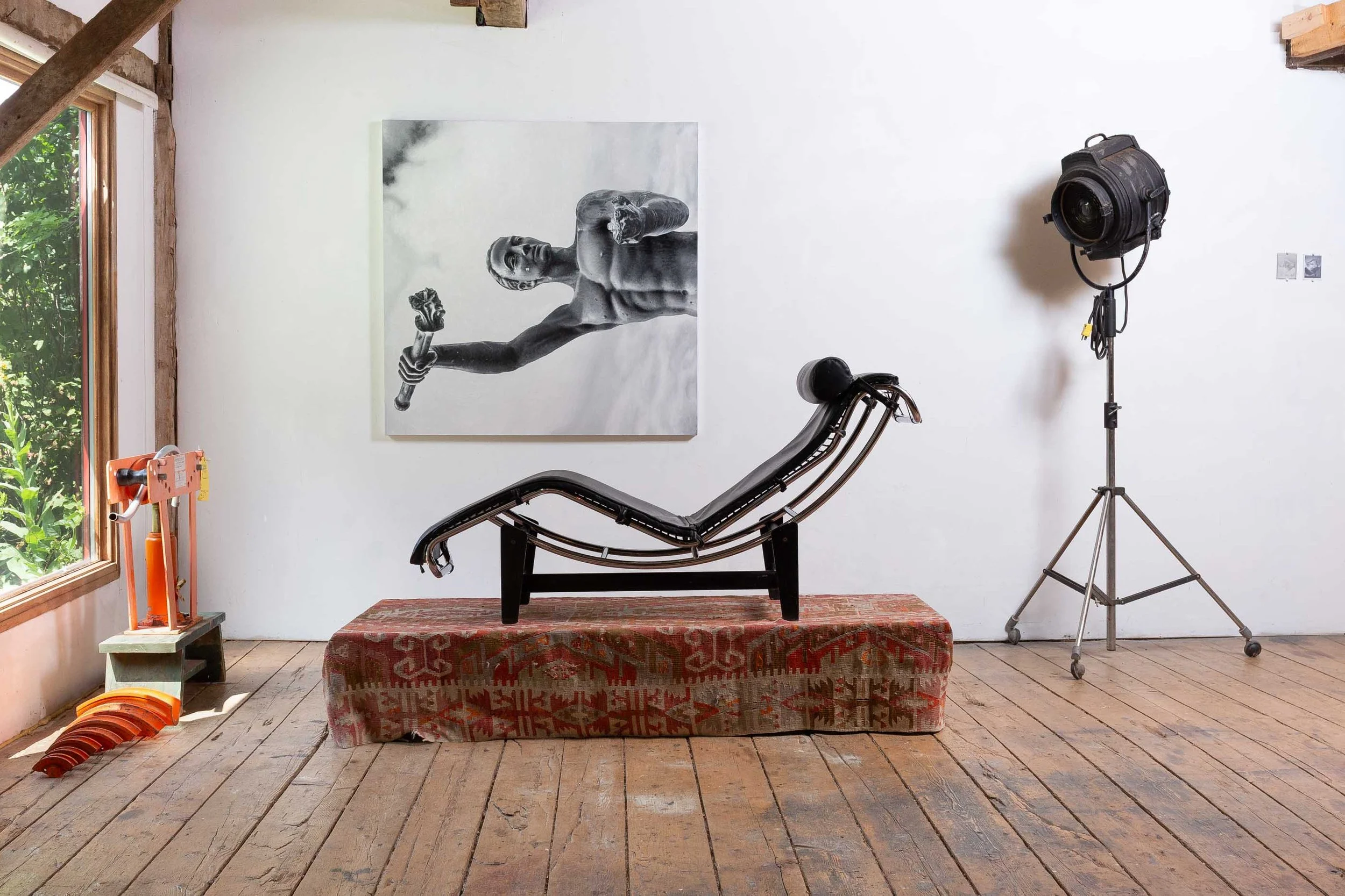 Brett Cody Rogers and Paul Jacobsen, Measure of Man, 2025, LC4 chair, pedestal, rug, 16 Ton pipe bender and components, chrome painted steel pipe, Bardwell & McAlister fresnel spotlight on rolling stand, wheelbarrow, hardhat, dimensions variable