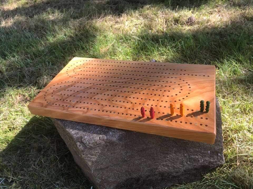 Father-Daughter Collaboration- Three Player Cribbage Board: Cherry with Brass inlay (father), Whittled and Dyed Maple Pegs (daughter).