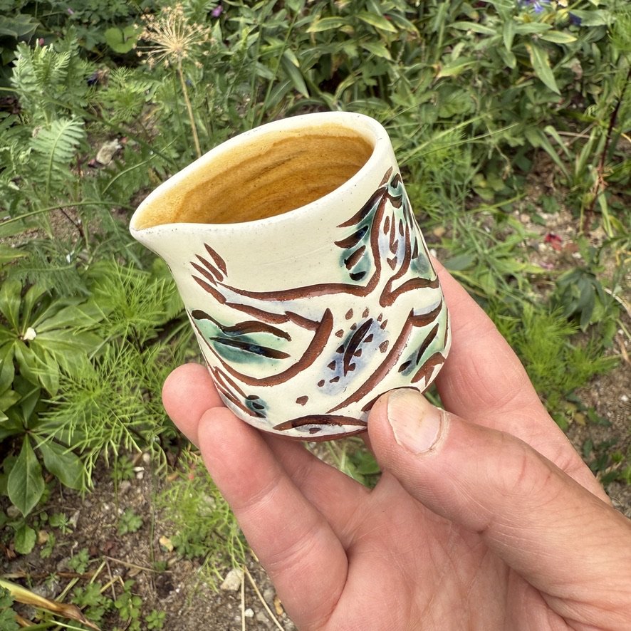 pot2945 - Cream jug with naked bather and ferry. Caramel glaze inside.