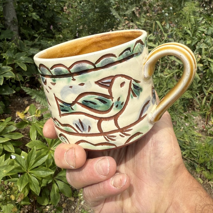pot2951 Slipware large tea mug with birds and foliage. Signature on base. Caramel glaze on handle and inside.