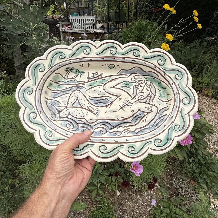 pot3033 - Scalloped platter with bathing sailor and tropical island.