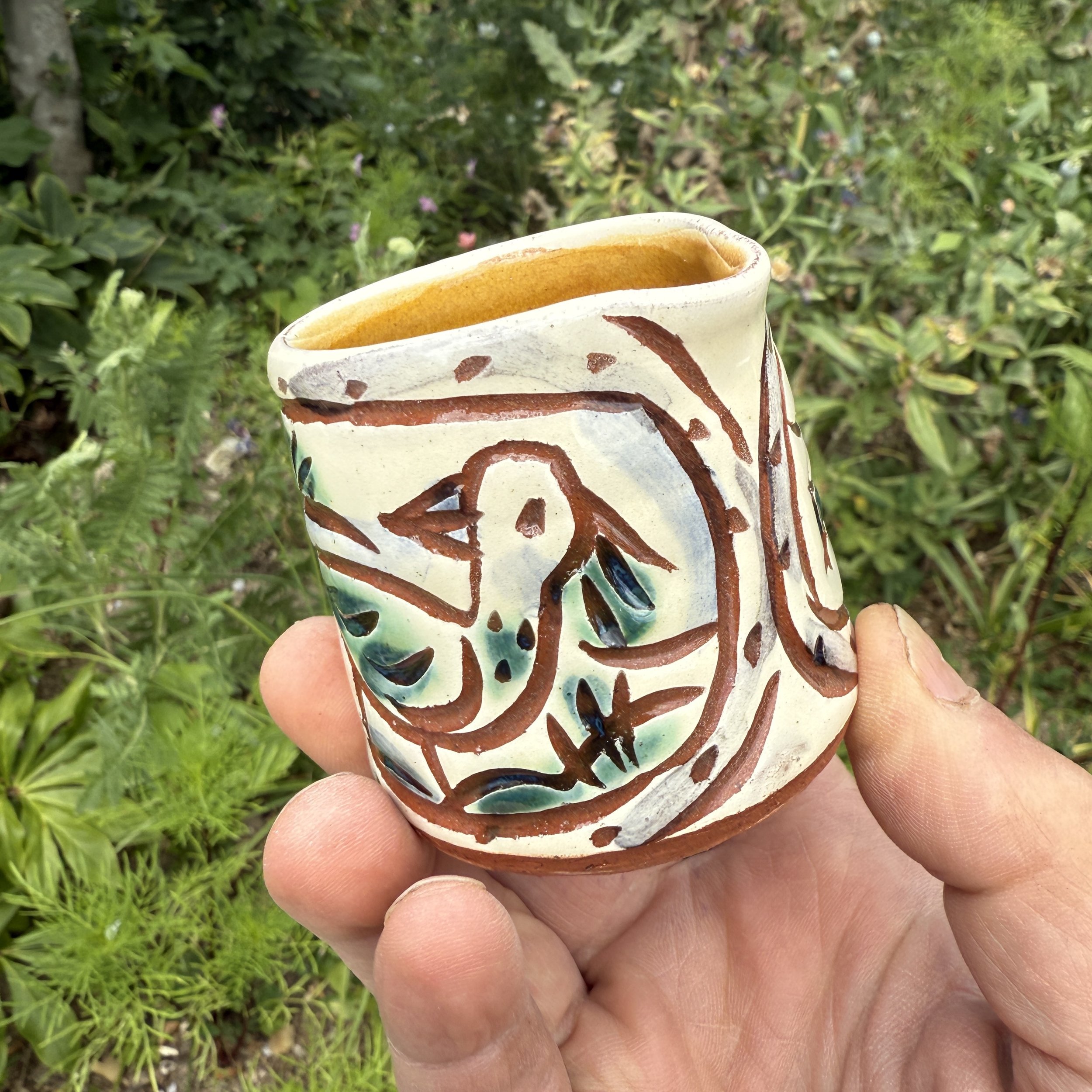 pot2948 - Cream jug with bird vignettes. Caramel glaze inside.