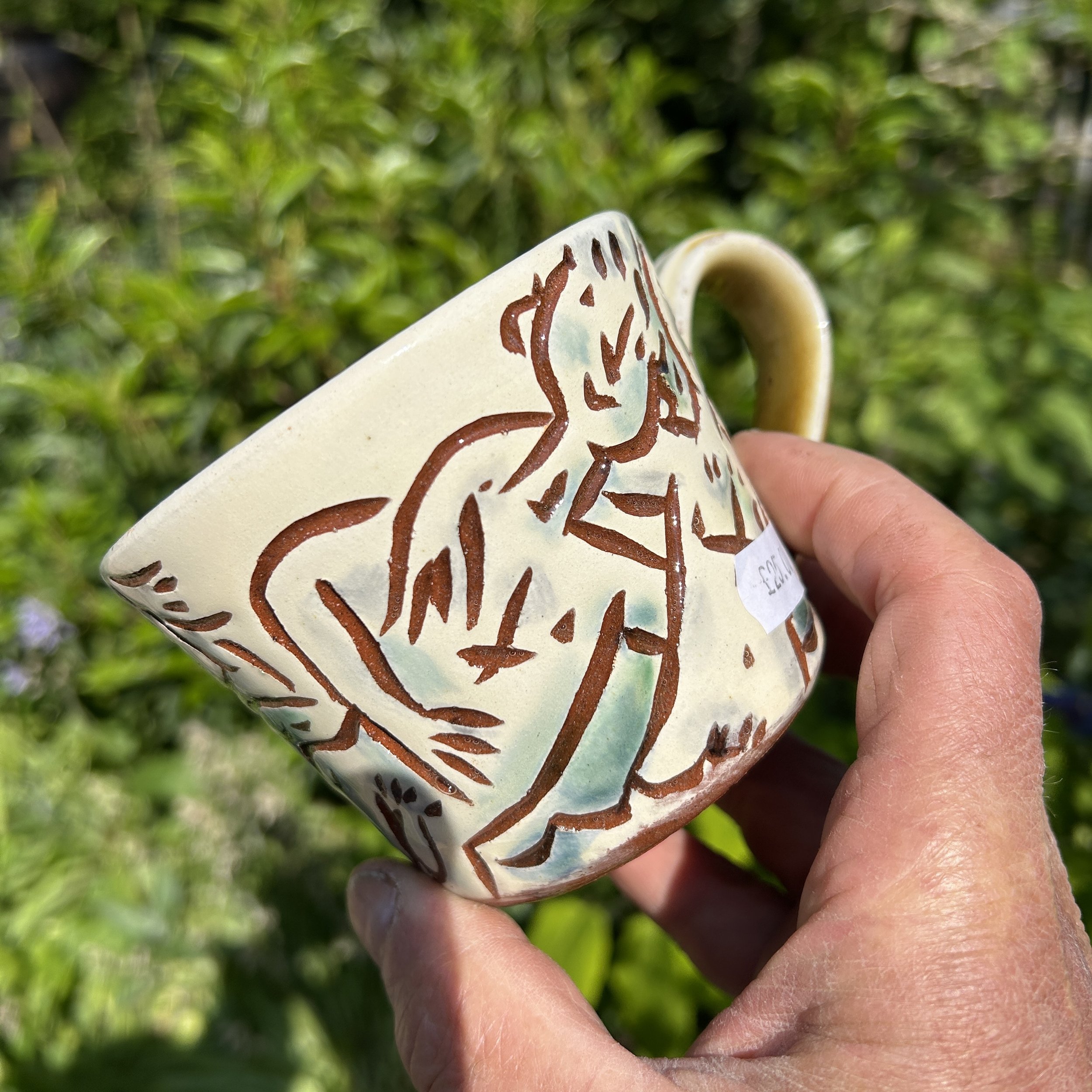 pot2890 Slipware  coffee mug with mates skinnydipping  in the sea.