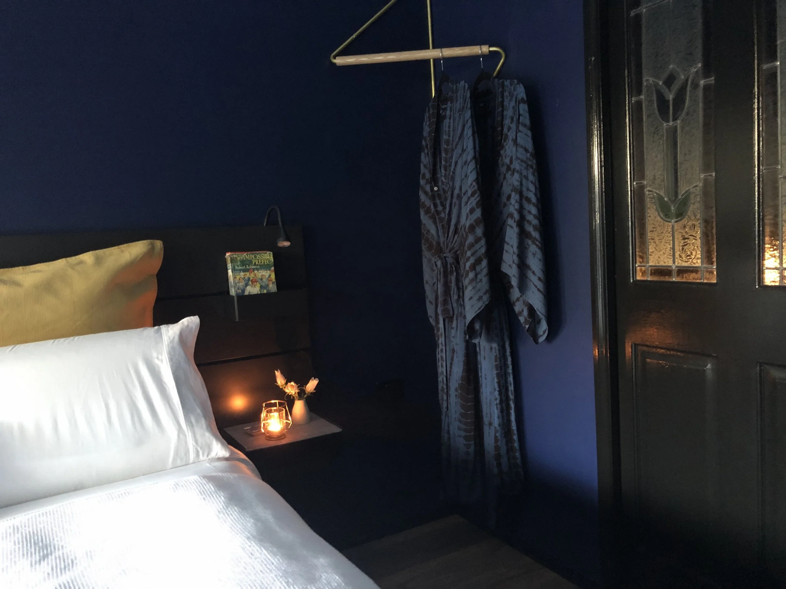 Salon bedroom with deep blue tones.