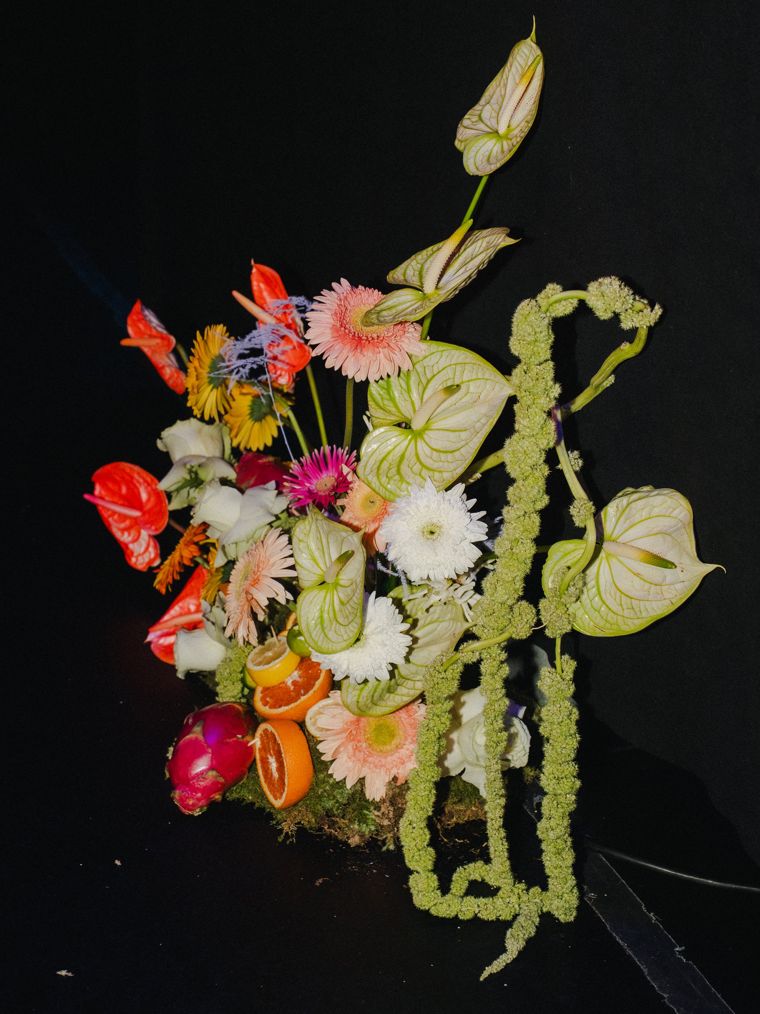 Rager wedding with technicolor wedding flowers adorned with citrus on the Lower East Side at the Bowery Ballroom. Photo by Inez Valencia.