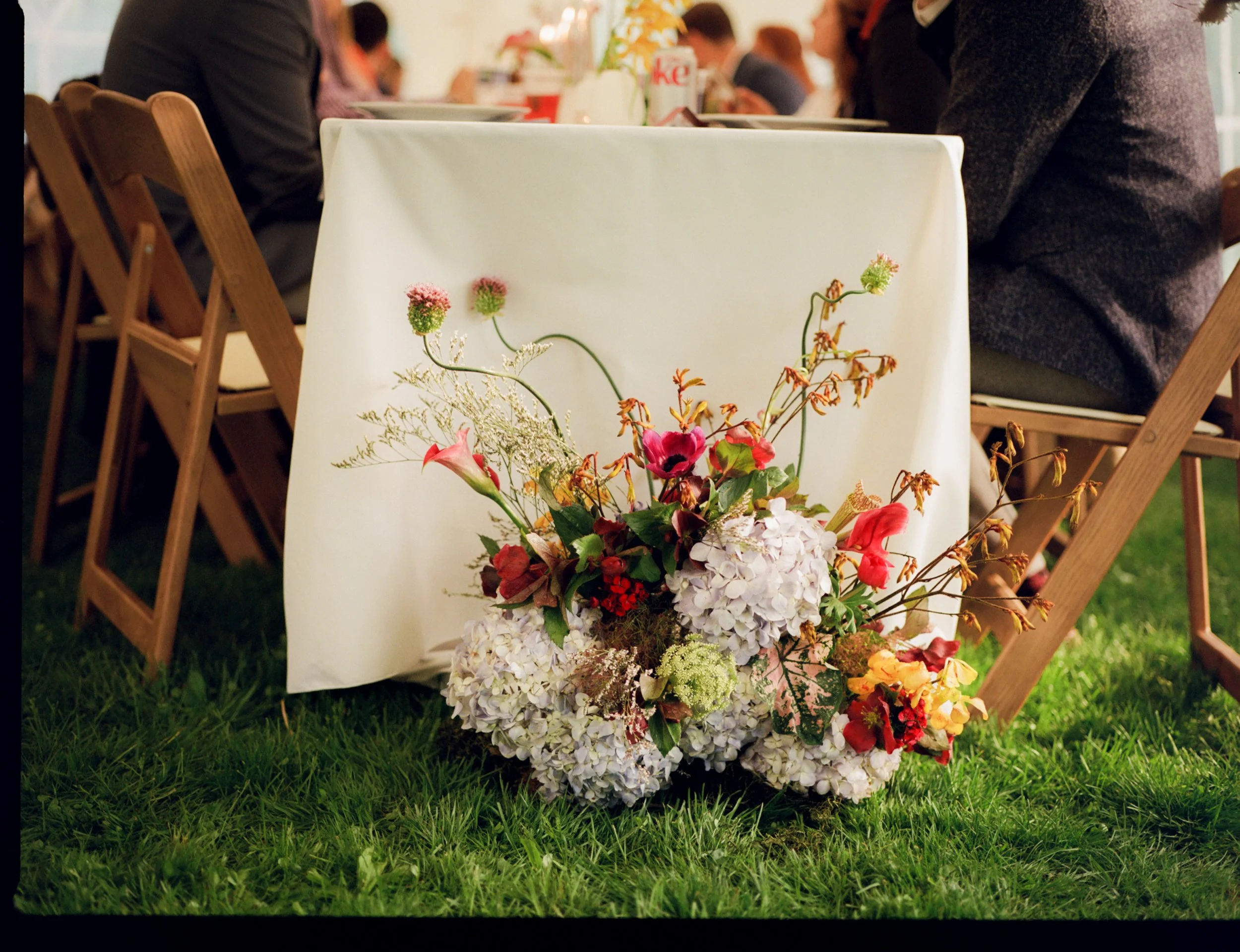 Piece of ceremony nest repurposed to frame beautiful table. Film photography by Mikala Gallo Photography.
